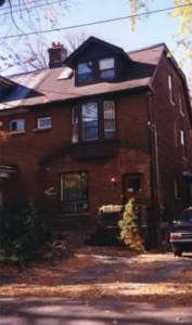 House in November 1995 with original porch removed by previous owner to install two parking spots. 